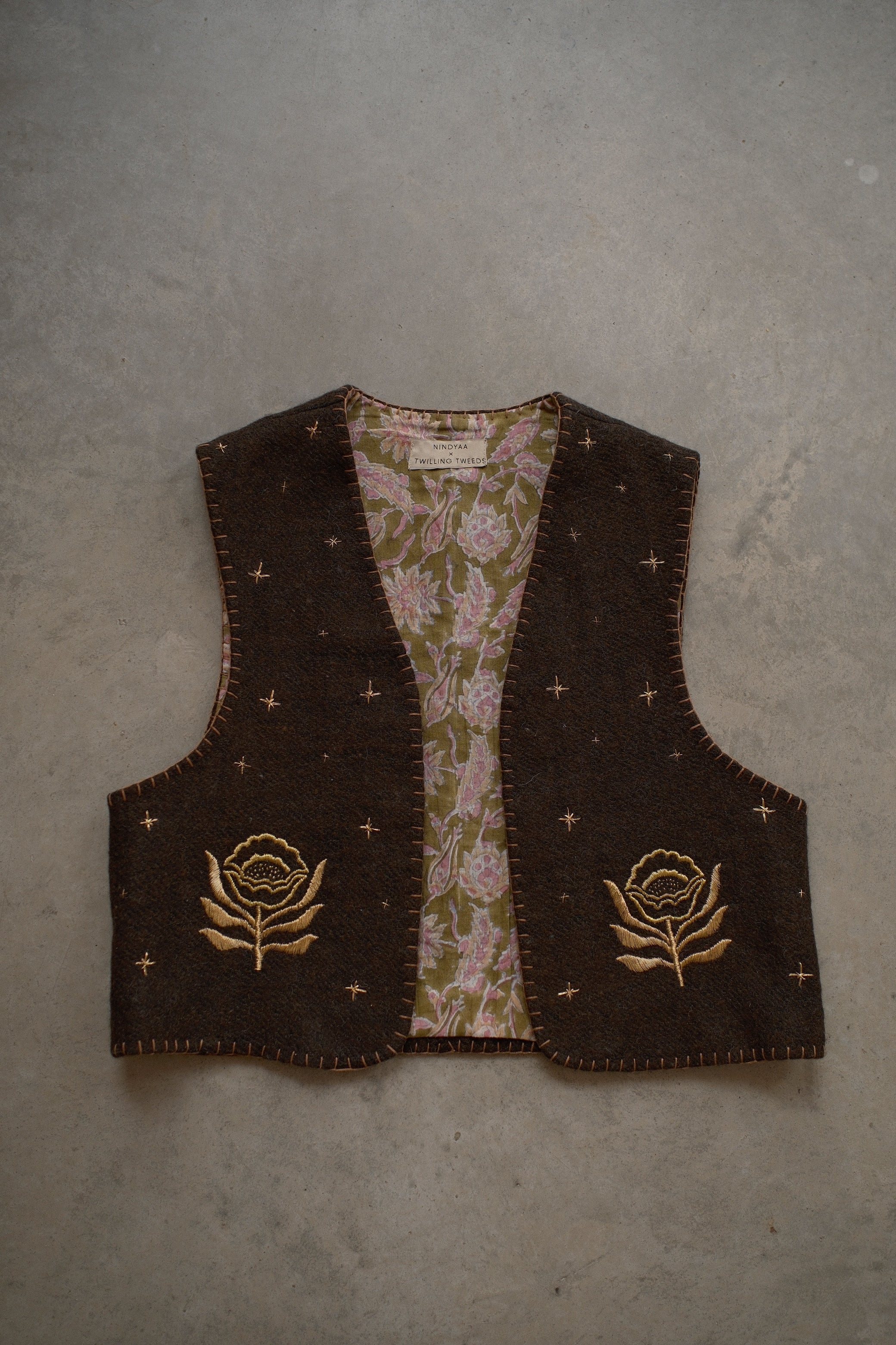 Wool vest with floral patterns and embroidered designs. Artisan fashion, sustainable luxury.